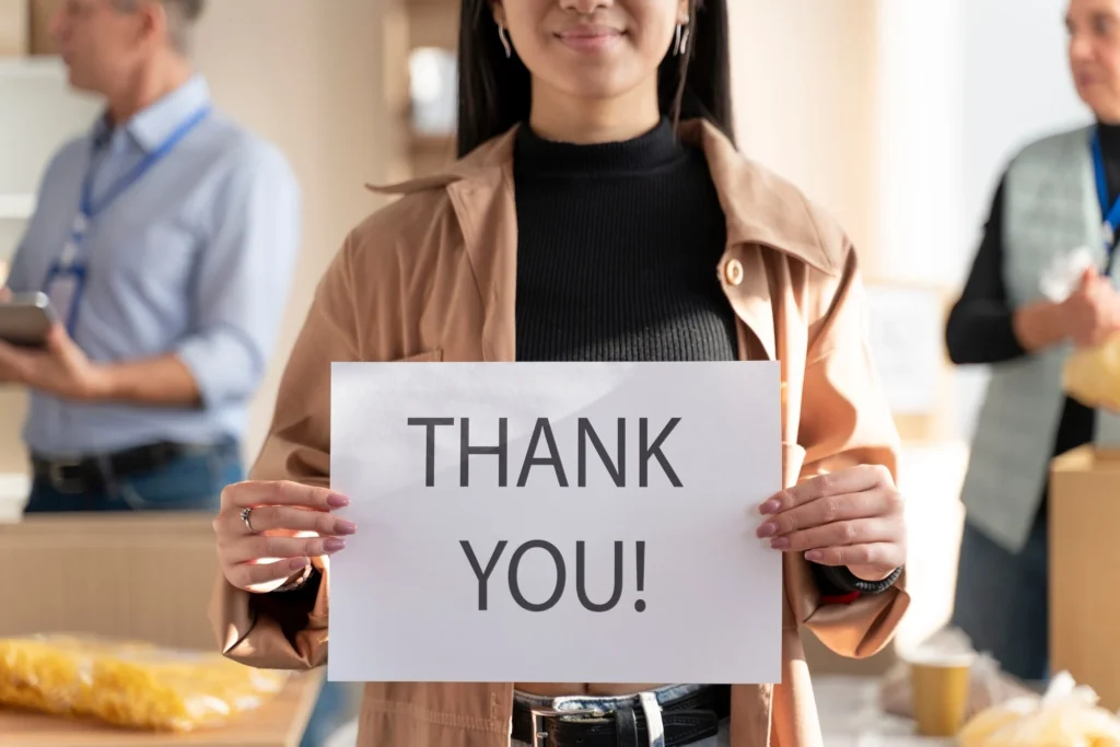 woman holding thank you sign