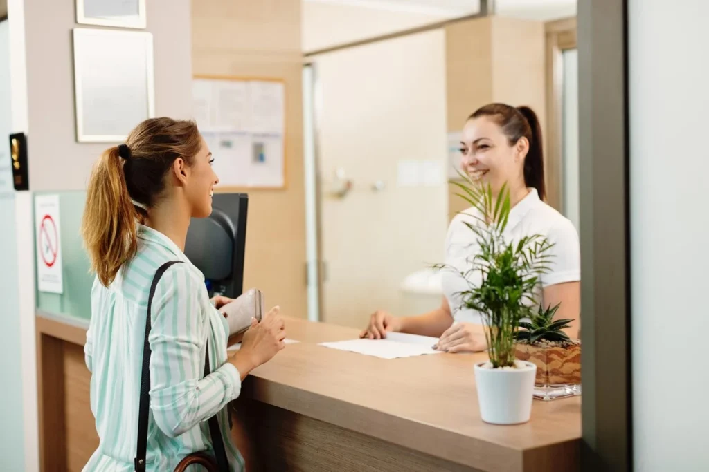 Woman Talking to Receptionist