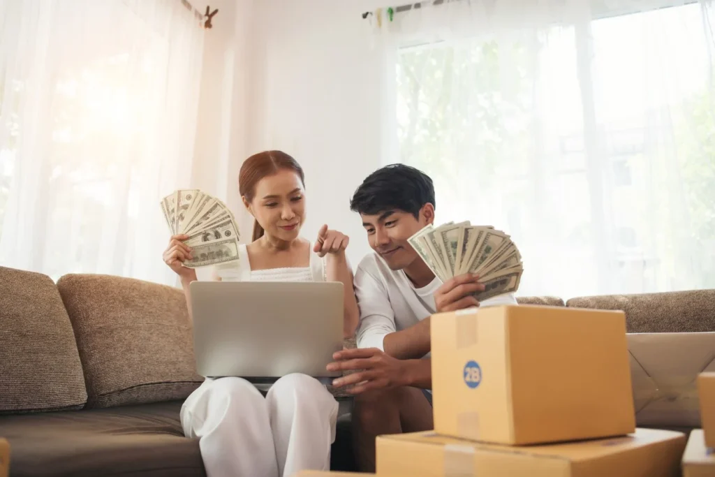 happy couple holding money for their affordable living