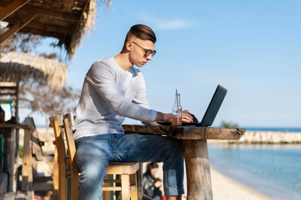 man working in front of beach