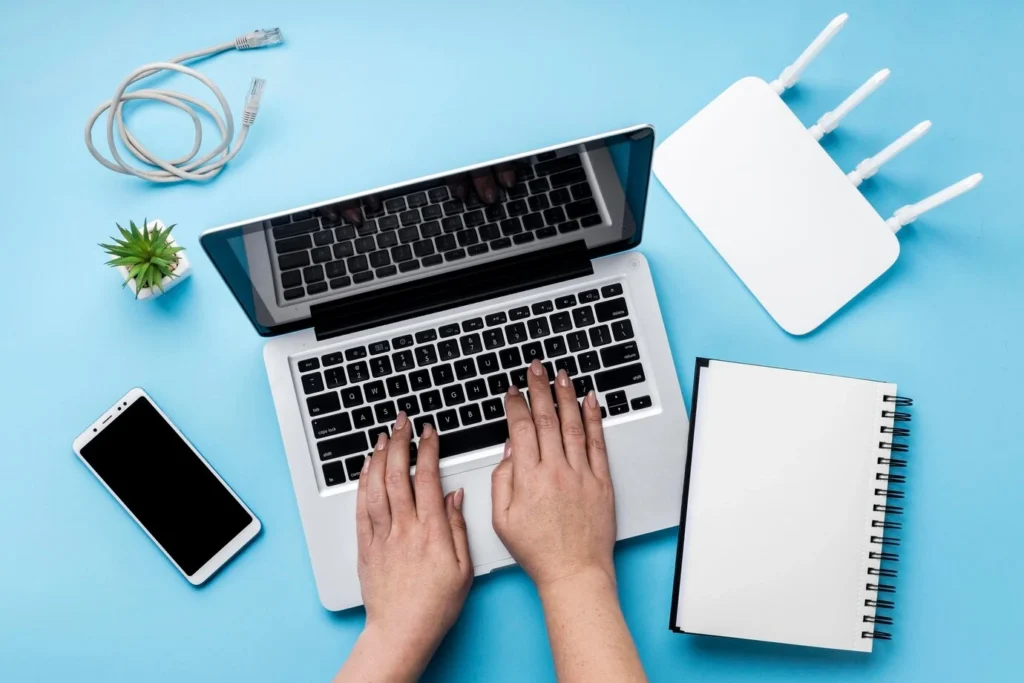 top view wi-fi-router with hands using laptop smartphone