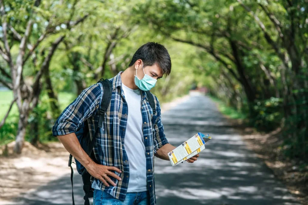 Man checking his map and follow local guidelines