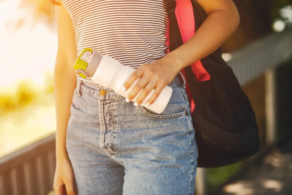 Woman holding a reusable water bottle